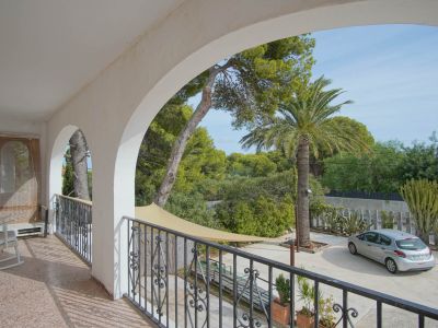 Covered balcony with garden views