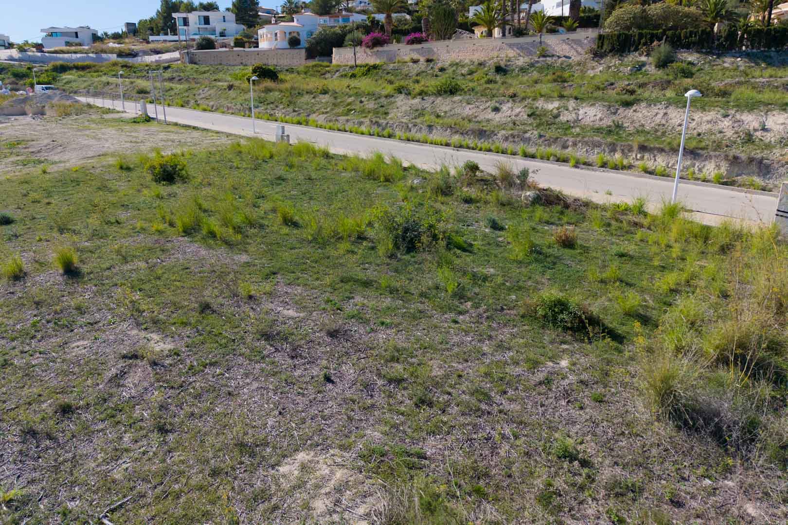 Flat urban plot featuring direct access from a paved road with street lighting, situated within the developing residential area of El Tesoro.