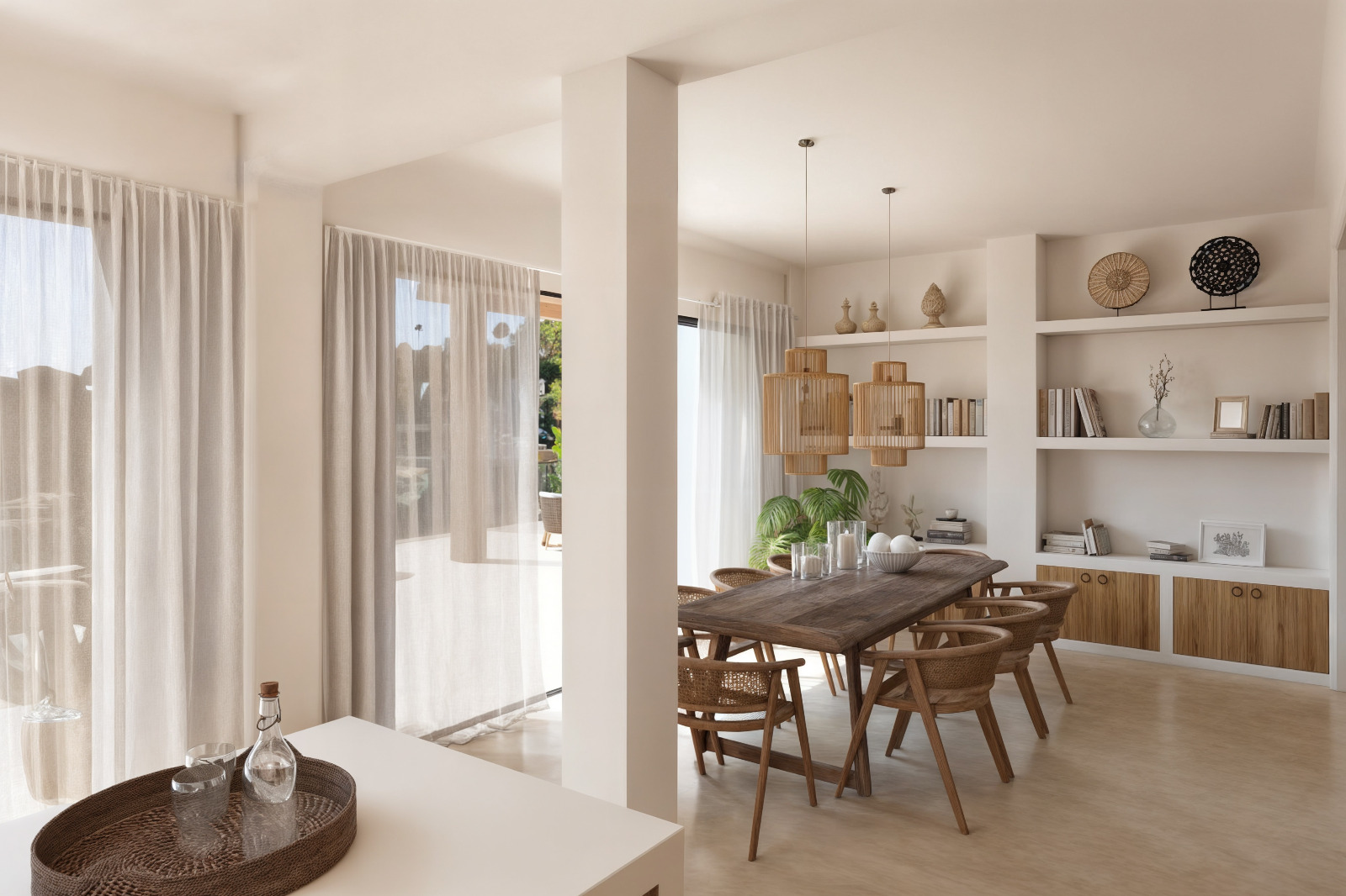 Ibicenco-style dining room featuring a solid wood table, rattan chairs, and integrated plaster shelving. Large windows with sheer curtains provide seamless access to the terrace.