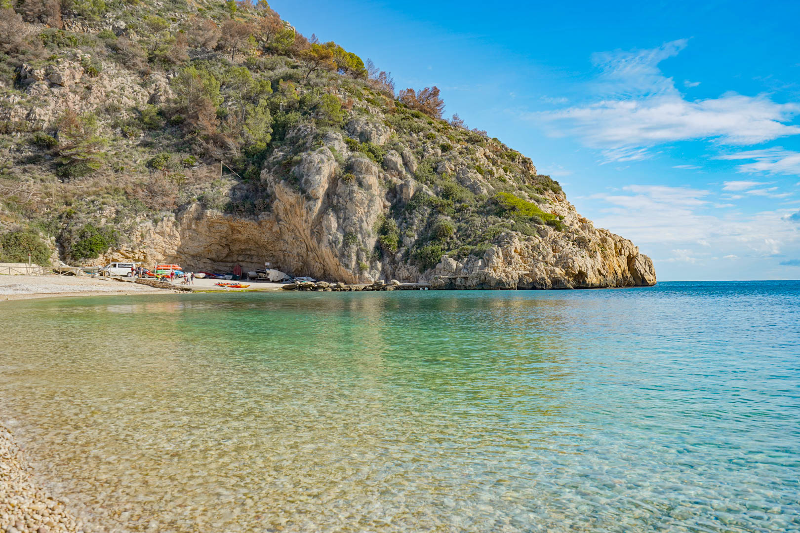 View of Granadella Beach in Jávea, featuring turquoise waters and limestone cliffs, located just a short drive from the villa.