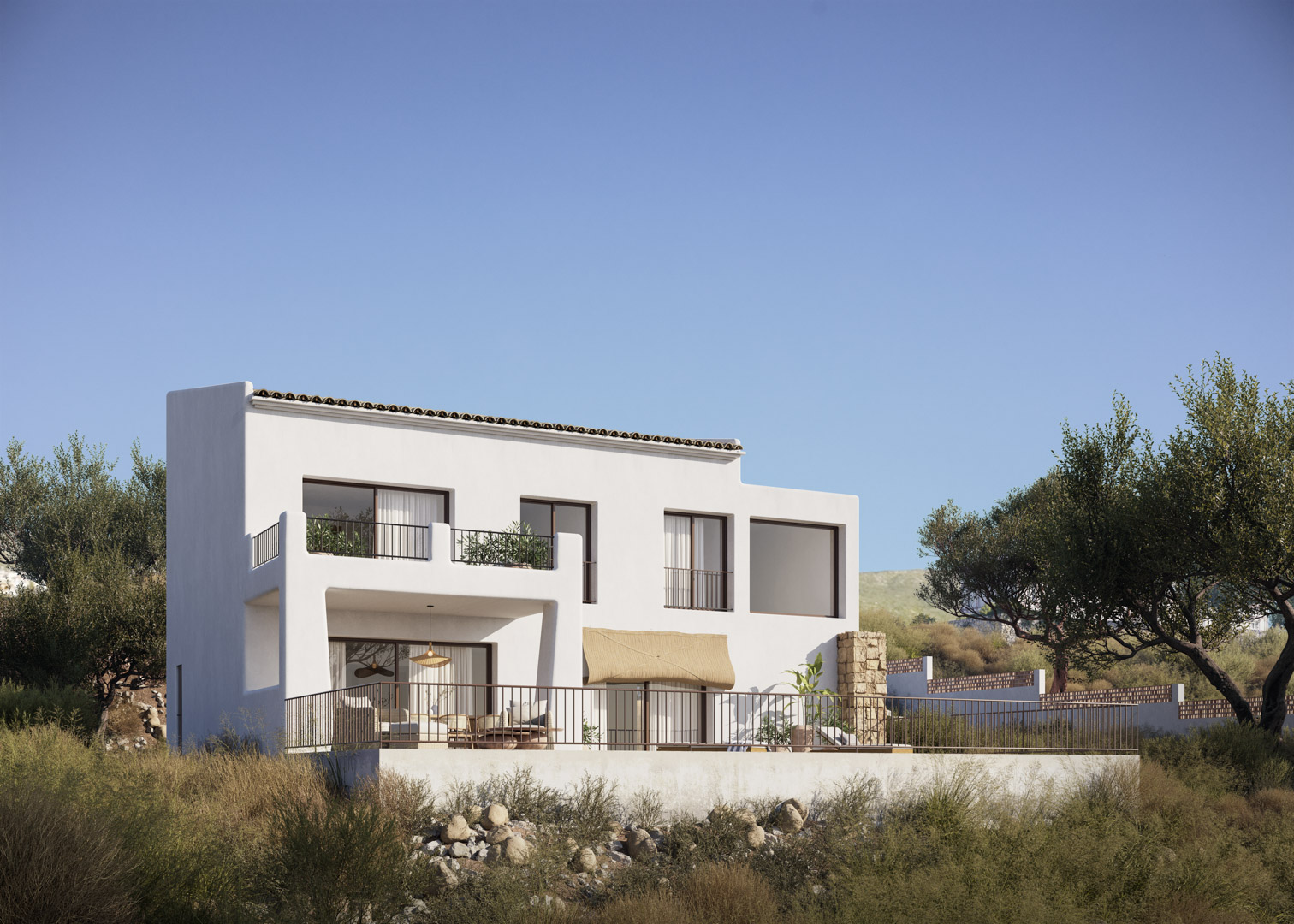 Exterior view of the Ibizan-style villa featuring white facades, large windows, and multi-level terraces set against a natural Mediterranean landscape.