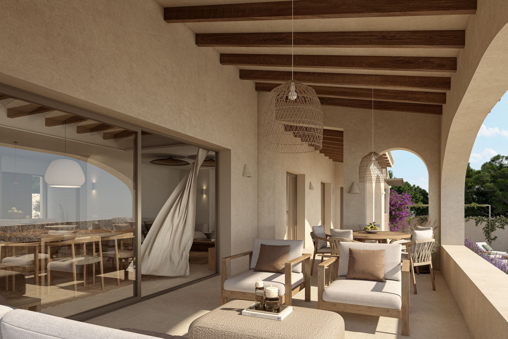 Covered terrace featuring exposed wooden beams, wicker pendant lighting, and neutral outdoor seating, seamlessly connected to the interior via large sliding glass doors.