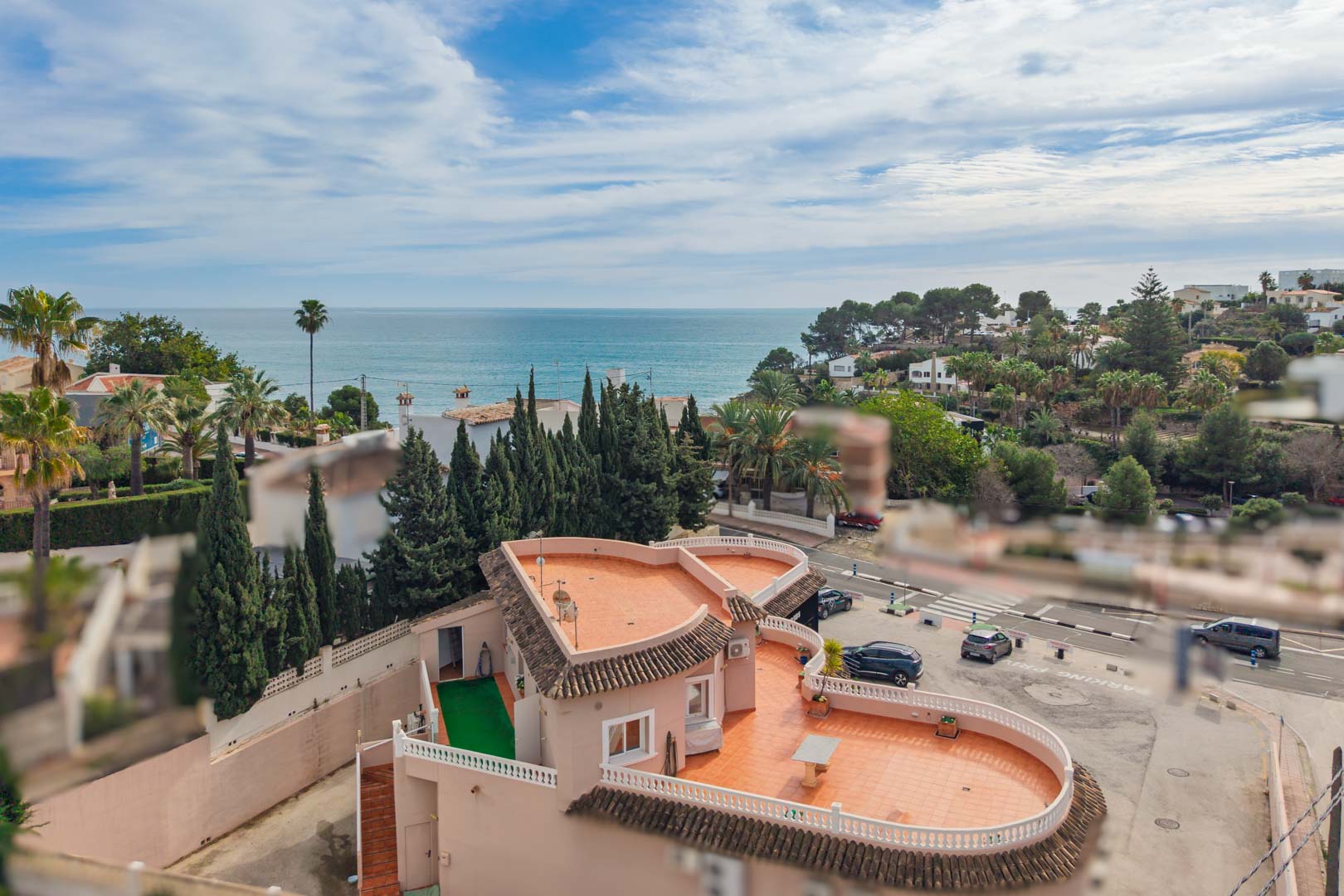 Panoramic Mediterranean Sea views from the elevated position, showcasing the coastal landscape, surrounding pine trees, and proximity to the Benissa shoreline.