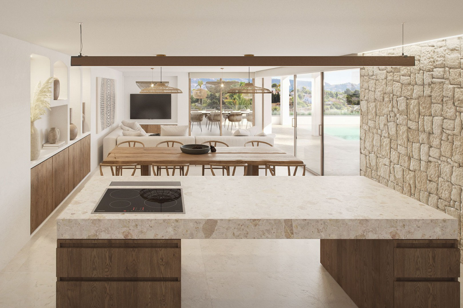 Detail of the kitchen island with stone countertop and induction hob, integrating with the dining and living area.