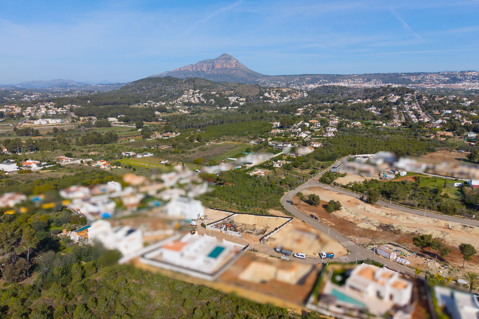 Aerial view of the Valsol residential area in Jávea, showcasing the green surroundings and the Montgó mountain in the background.