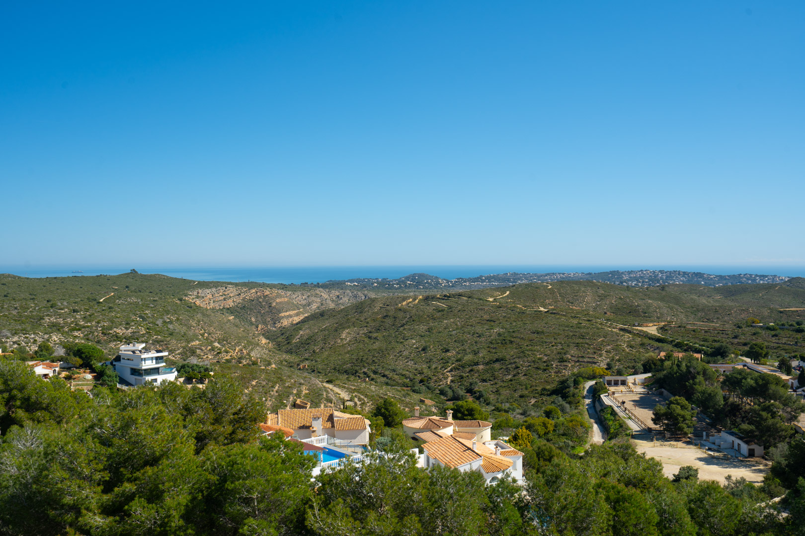 Panoramic views from the property overlooking the Granadella natural park and the Mediterranean Sea, featuring rolling green hills and the distant coastline.