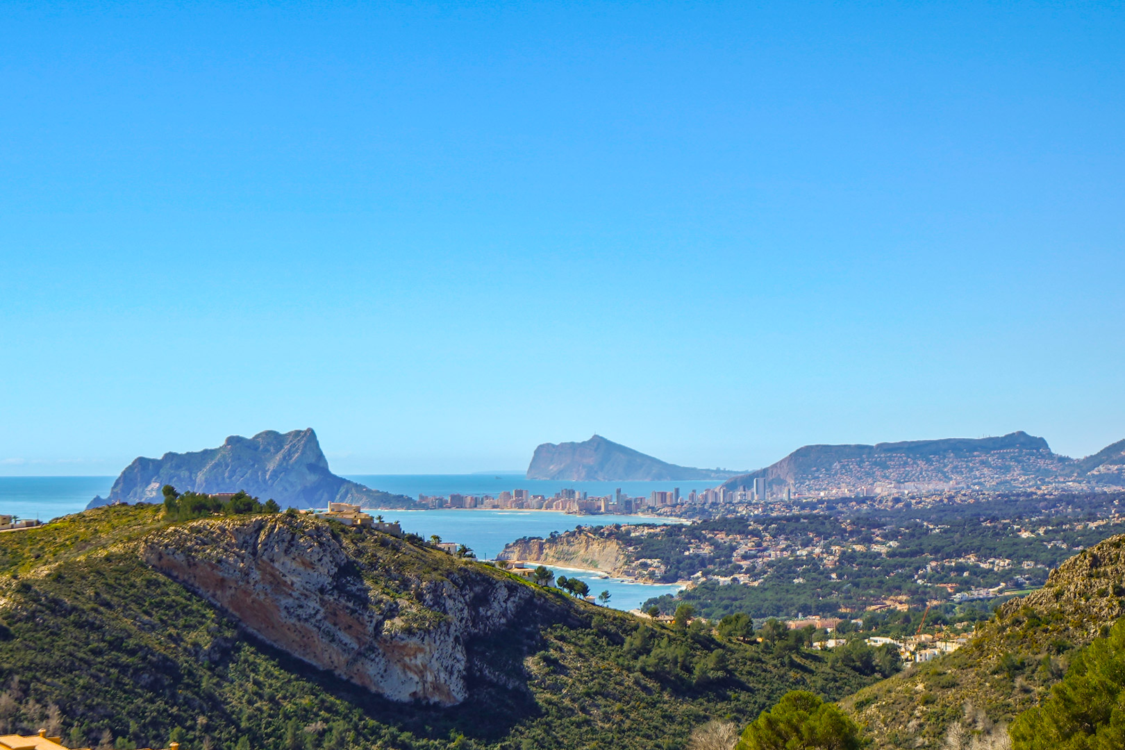 Panoramic views from the property featuring the Peñón de Ifach in Calpe, the Benissa coastline, and the distant Benidorm skyline under a clear blue sky.