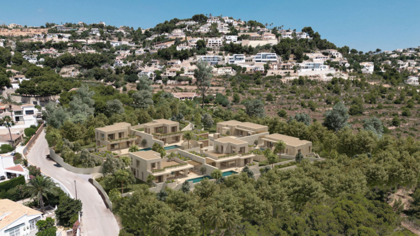 Aerial view of a modern residential complex featuring light-toned villas with private pools, nestled into a green, tree-covered hillside.