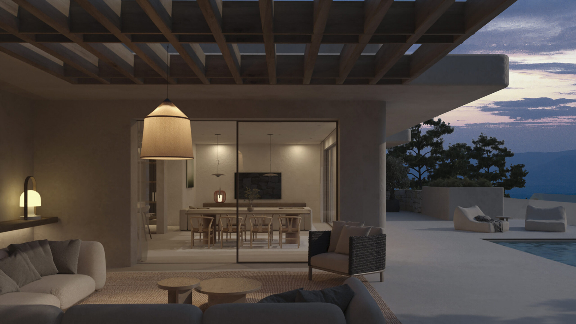 An inviting outdoor living area with contemporary sofas and a fabric pendant lamp, seamlessly connecting to an elegant indoor dining space with mountain views at dusk.