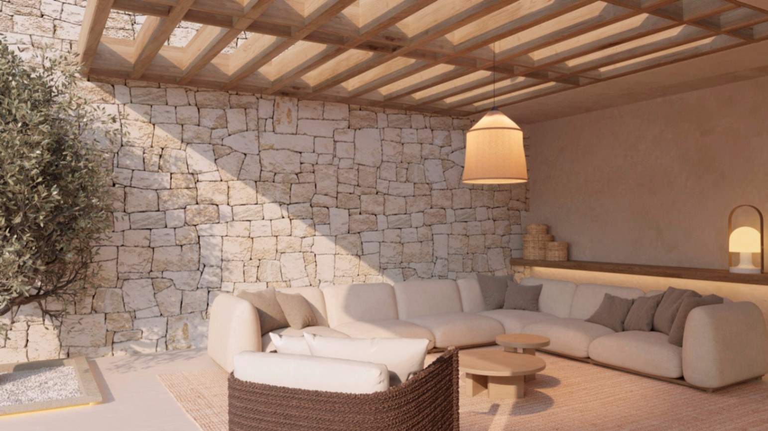Outdoor lounge area featuring a natural stone wall, wooden pergola, and a large L-shaped sofa. Ambient lighting from a hanging pendant complements the modern design.