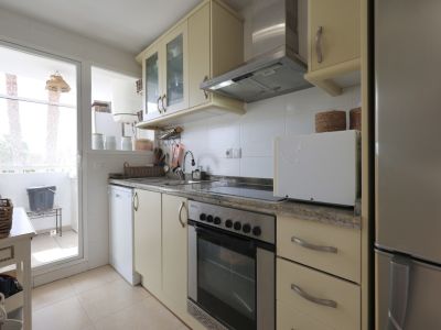 Bright kitchen featuring granite countertops, stainless steel appliances, and balcony access.