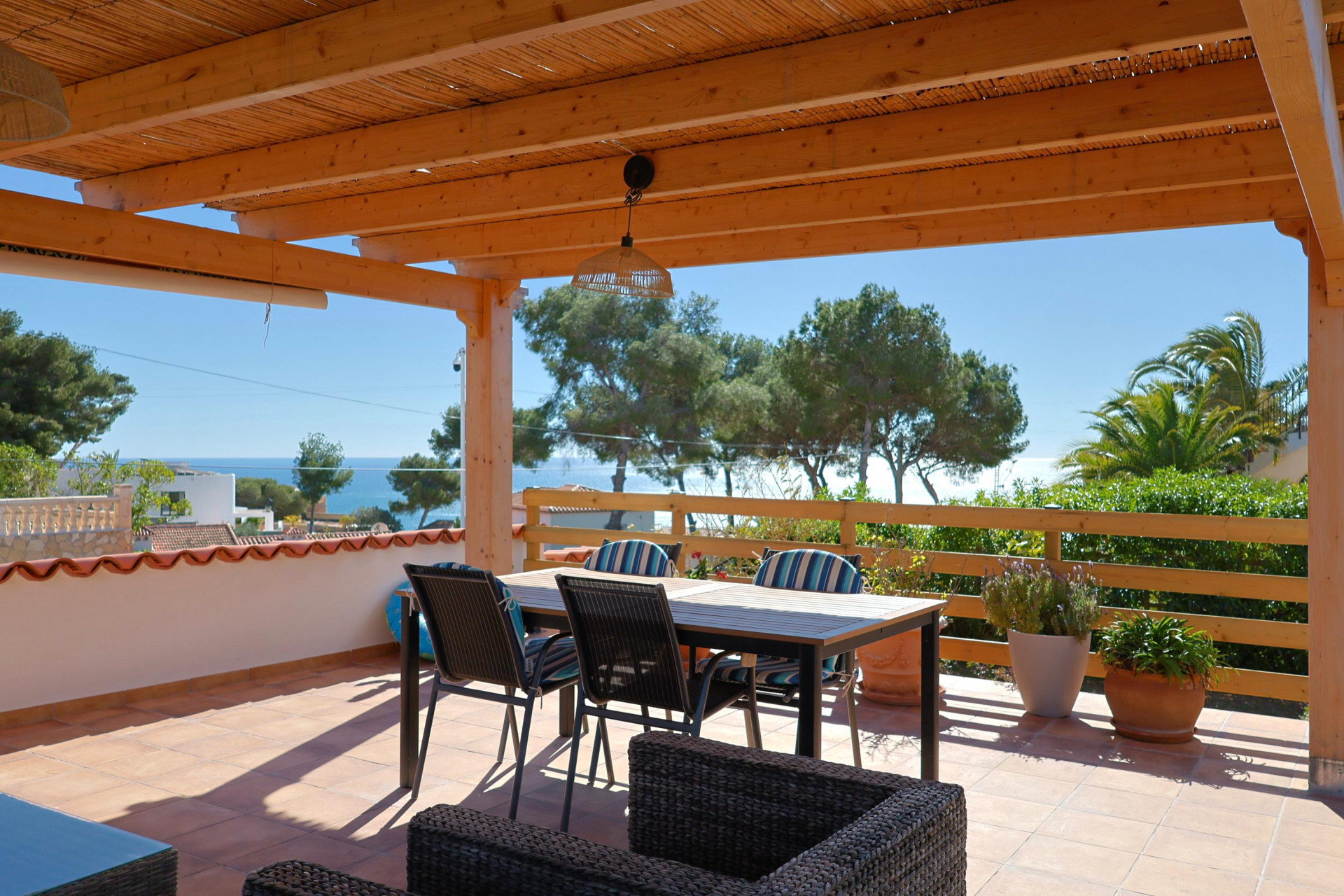 Covered terrace featuring sea views and dining furniture.