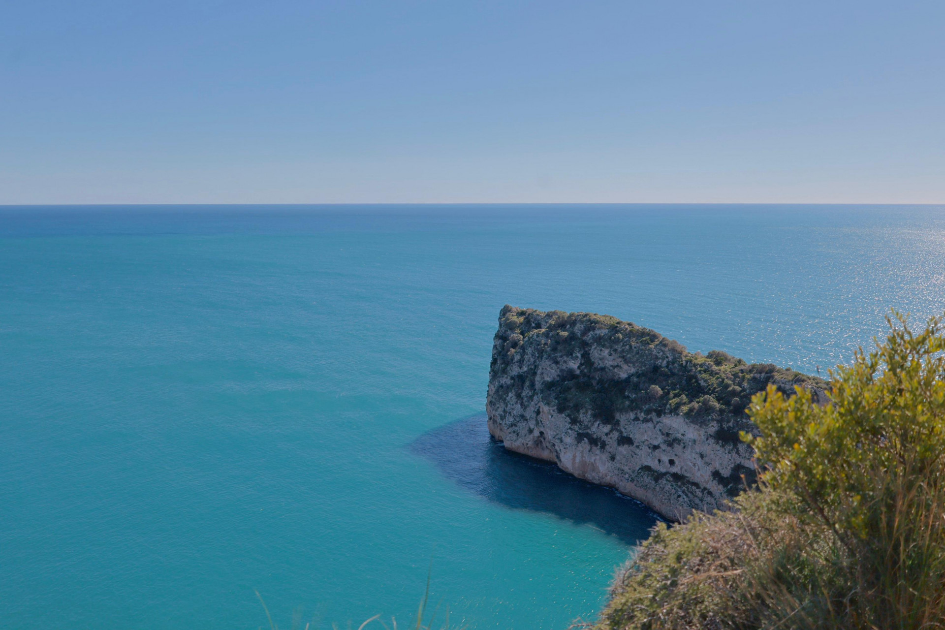 Panoramic view of the Mediterranean Sea and rocky cliff from the Jávea coastline.