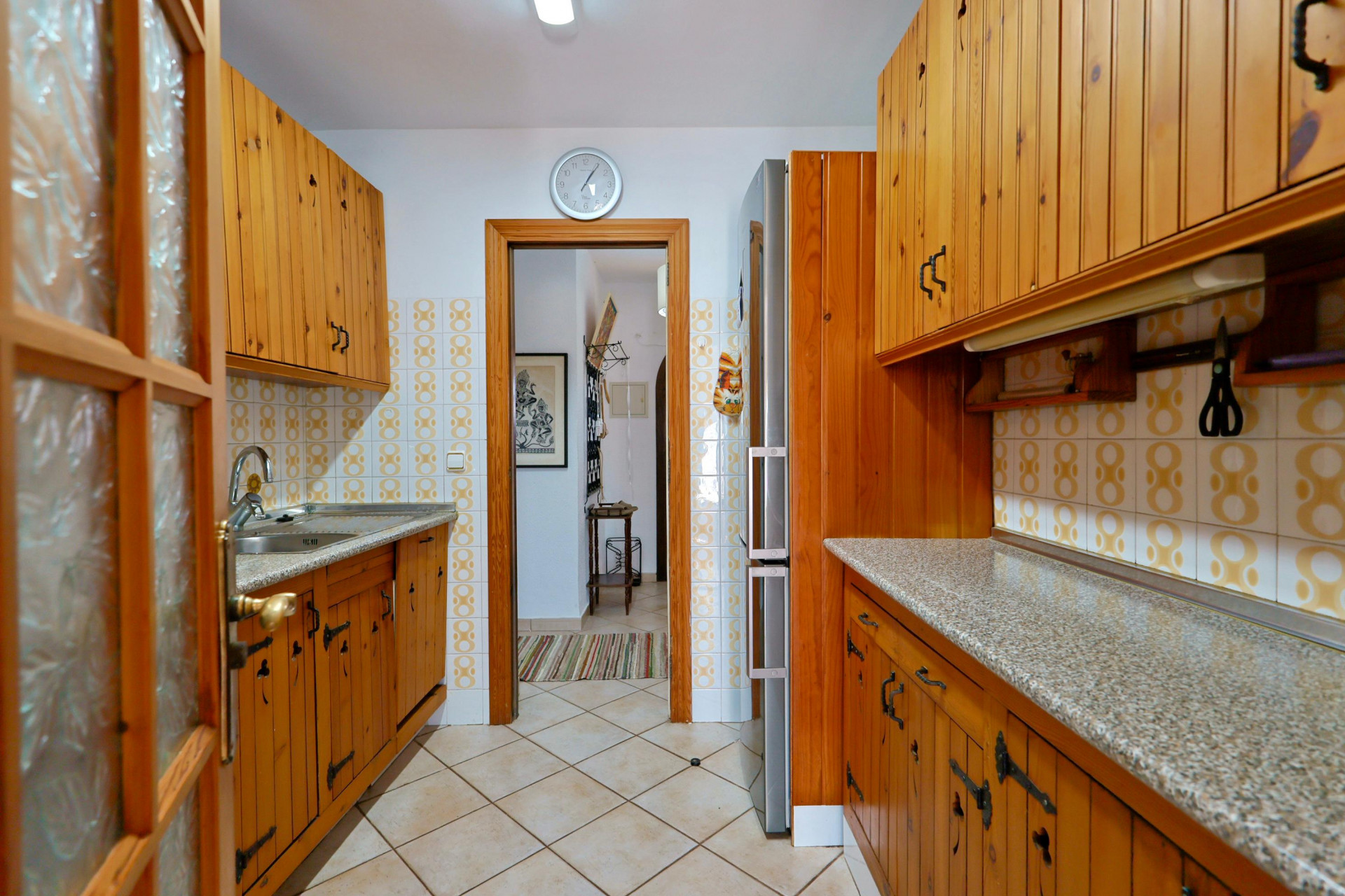 Rustic kitchen featuring wood cabinets and granite countertop.