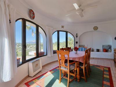 Bright dining room featuring arched windows with panoramic views of the Jávea landscape.