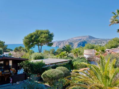 Panoramic view of Jávea featuring a wooden cabin and lush greenery.