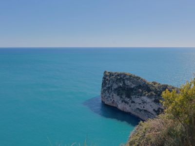 Panoramic view of the Mediterranean Sea and rocky cliff from the Jávea coastline.