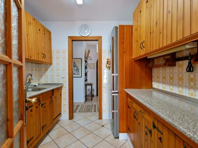 Rustic kitchen featuring wood cabinets and granite countertop.