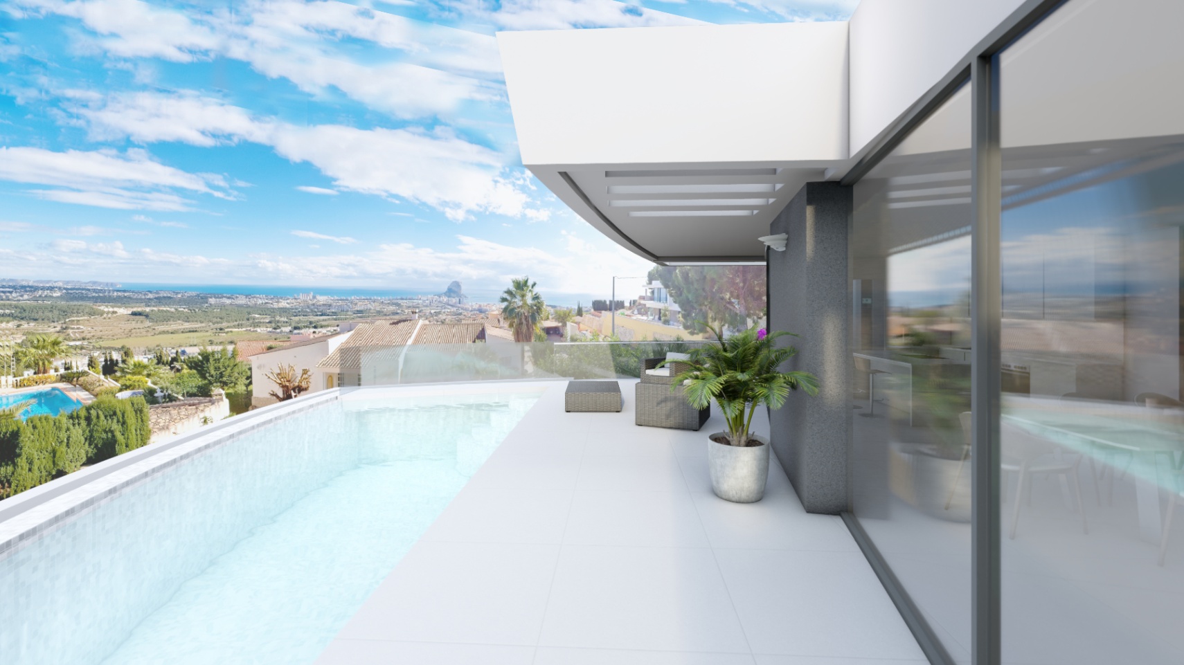 Elevated terrace featuring an infinity pool with glass balustrades and panoramic views of the Peñón de Ifach. Large sliding glass doors connect the white-tiled exterior to the interior.
