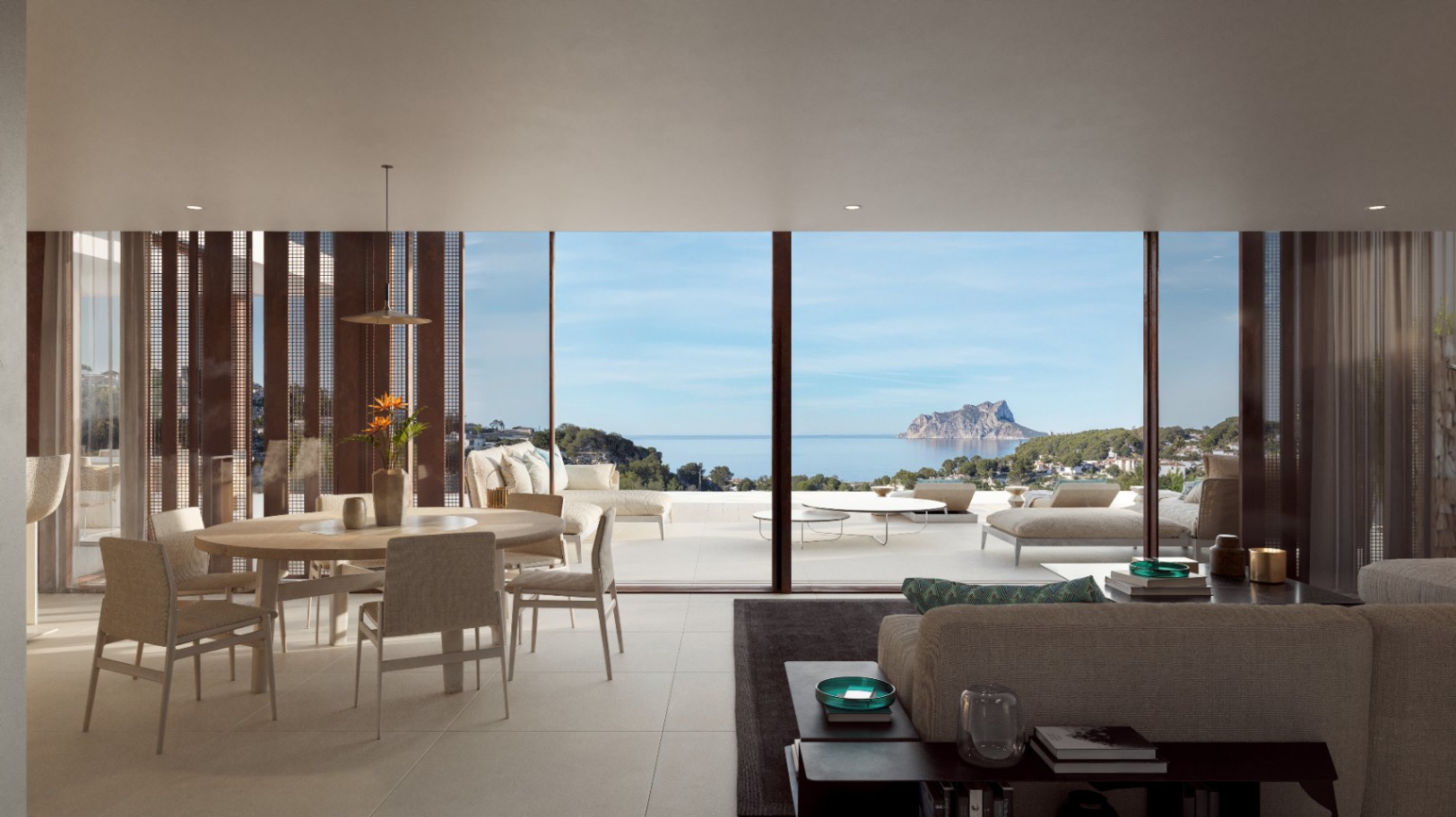 Open-plan living and dining area featuring floor-to-ceiling glass doors that reveal panoramic Mediterranean views and the Peñón de Ifach.