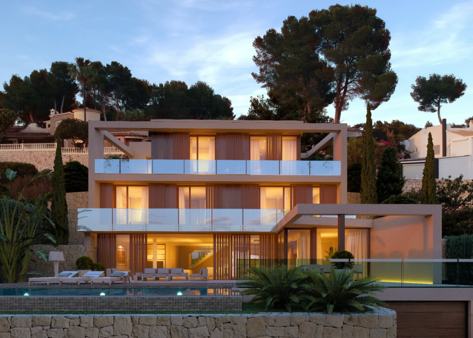 Front view of modern villa featuring an illuminated pool and glass balconies in Benissa.