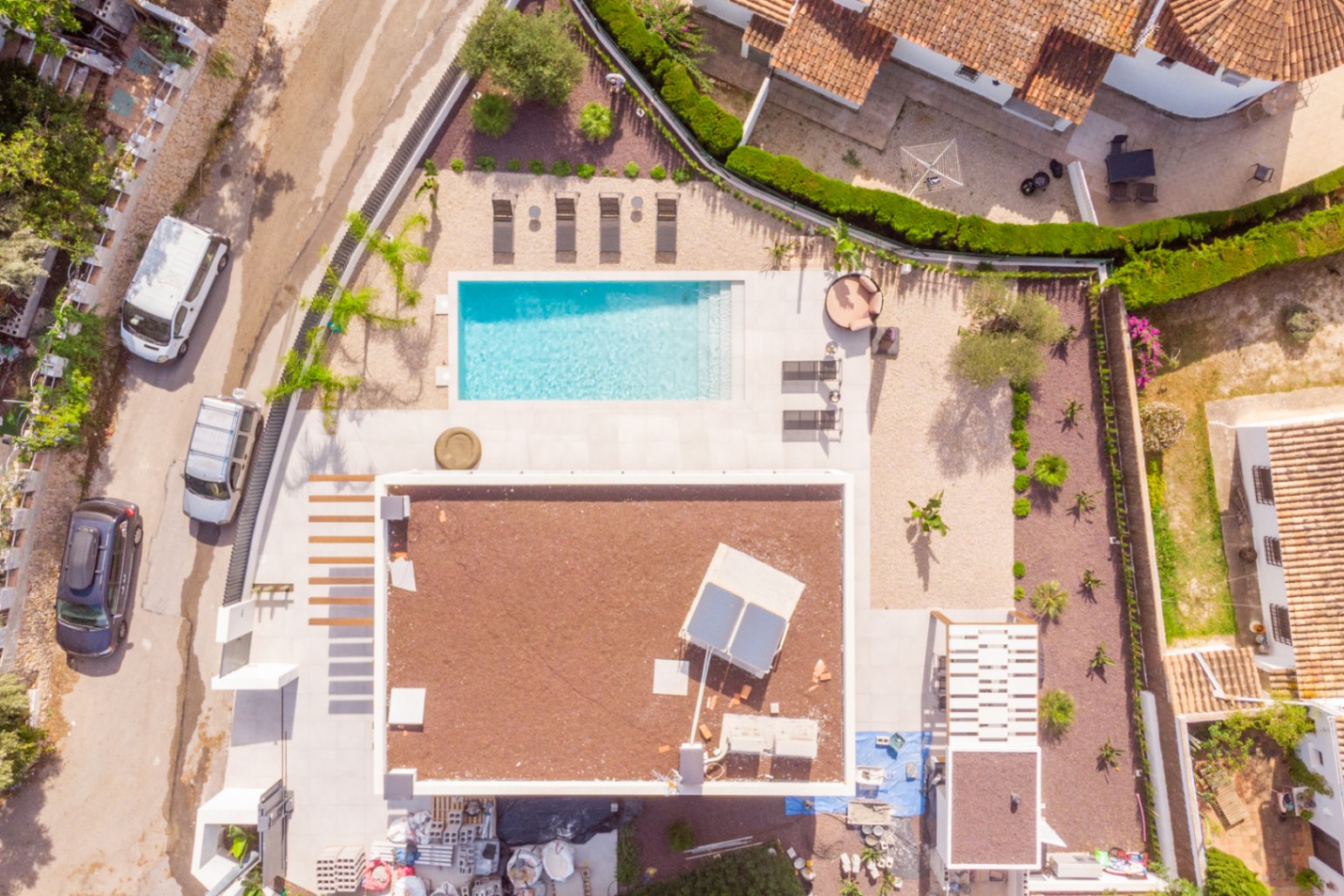 Aerial view of the villa with a rectangular pool, sun deck, and Mediterranean garden.
