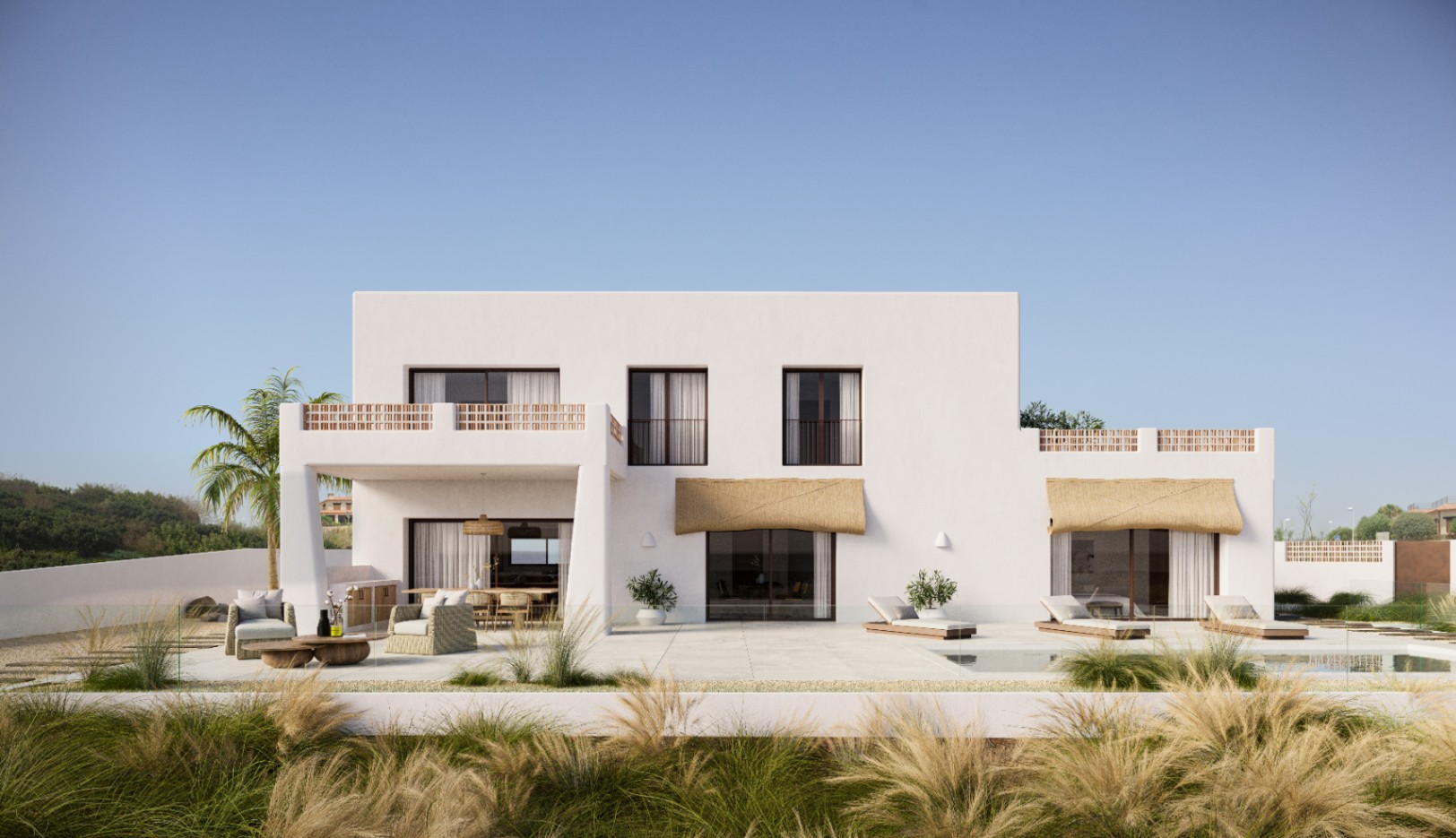 Exterior facade of the white minimalist villa featuring a large stone terrace, outdoor lounge, swimming pool, and balconies with decorative terracotta railings.