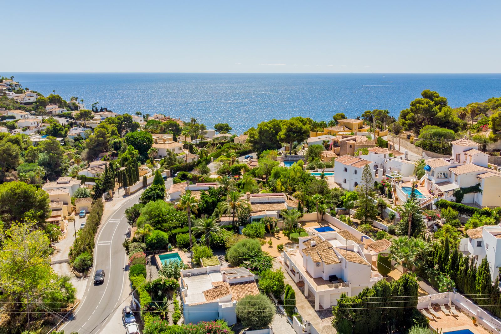 Panoramic aerial view of the Baladrar coastal area, showcasing the proximity to the Mediterranean Sea and the lush landscape of traditional villas.