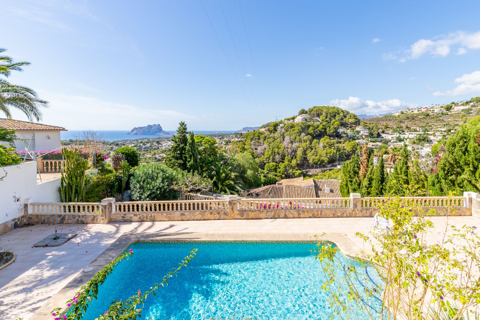 Private swimming pool and stone terrace featuring a classic balustrade, with panoramic views of the Mediterranean Sea and the Peñón de Ifach.