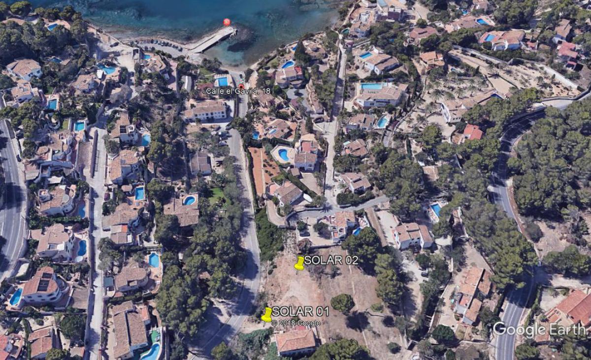 Aerial view highlighting the location of plots Solar 01 and Solar 02, situated within walking distance of Cala Advocat and the Mediterranean coastline.