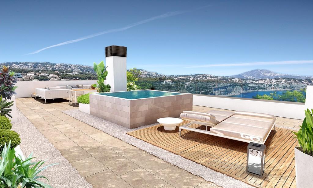 Rooftop solarium featuring an elevated plunge pool, wooden decking with sun loungers, and glass railings offering panoramic views of the Mediterranean coastline.
