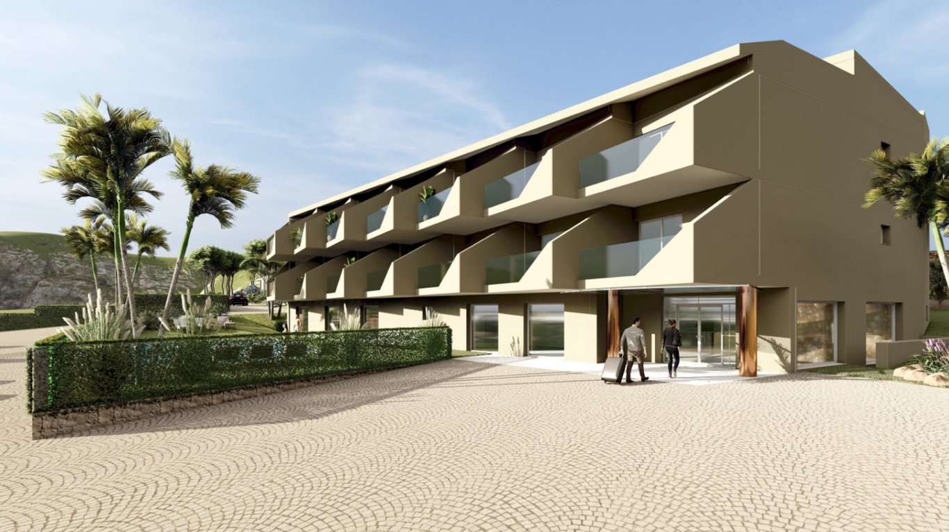 Exterior facade of the boutique hotel featuring private glass balconies, a glazed main entrance, and a cobblestone forecourt with Mediterranean landscaping.