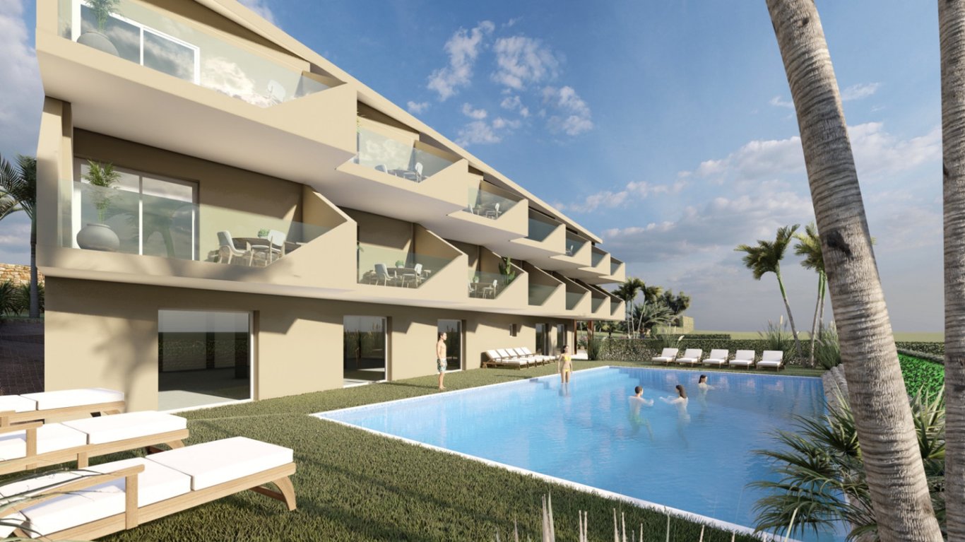 Three-story modern facade featuring geometric balconies with glass railings overlooking a rectangular swimming pool and sun terrace with wooden loungers.