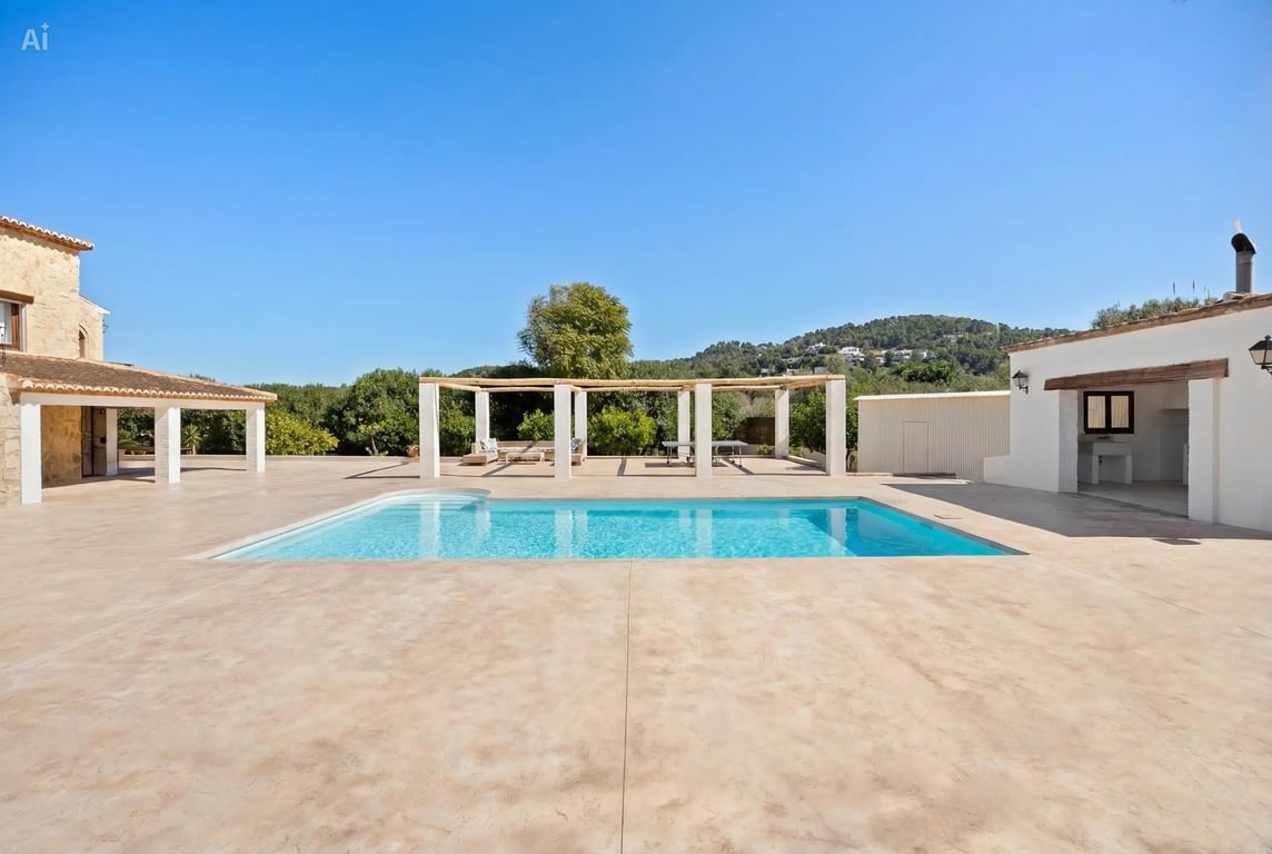 A 5x10 meter swimming pool set within a spacious paved terrace, featuring a wooden pergola, outdoor kitchen building, and scenic mountain views.