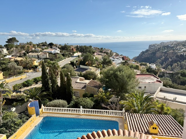 Elevated view overlooking the private swimming pool with white balustrades, featuring panoramic vistas of the Mediterranean Sea and the surrounding coastal landscape.