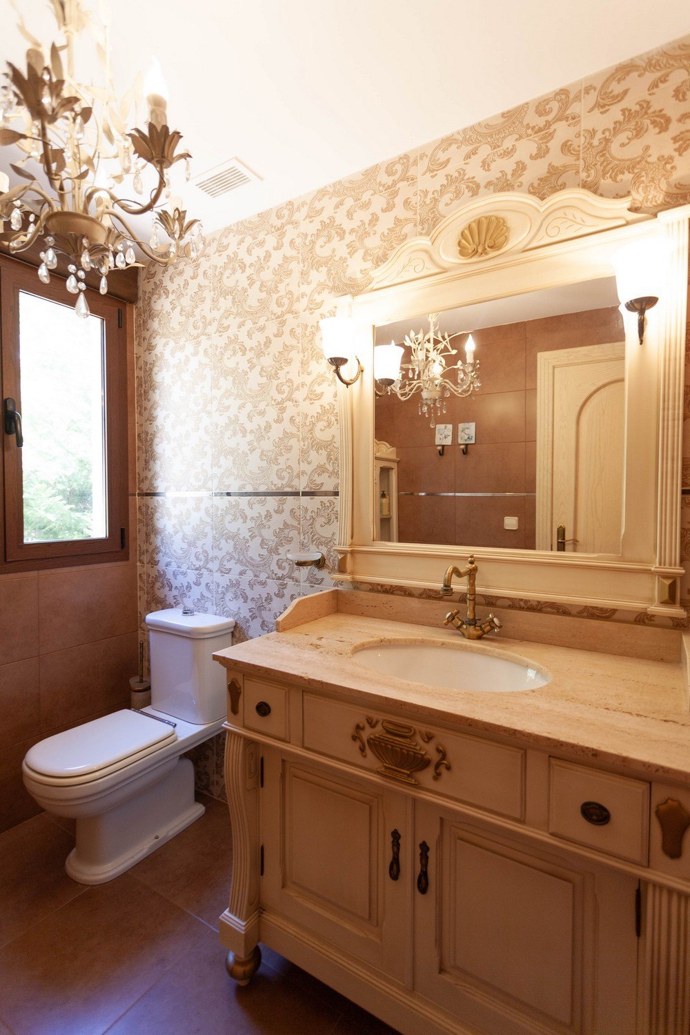 Classic-style bathroom detail with marble vanity and floral wallpaper.