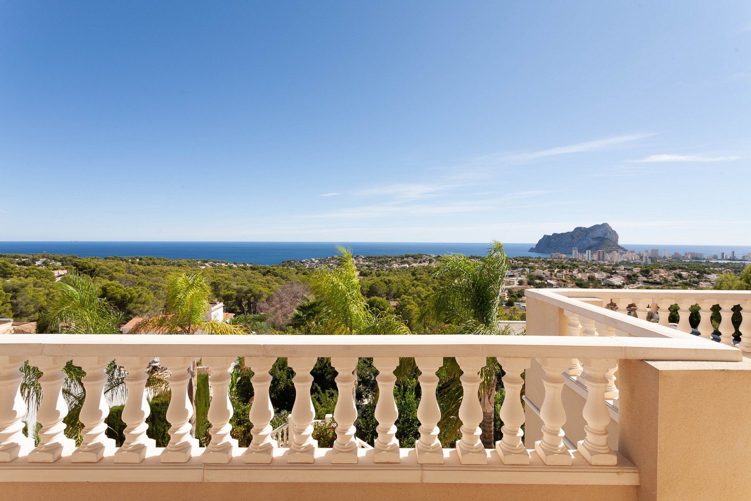 View from the terrace with stone balustrade towards the sea and Peñón de Ifach.