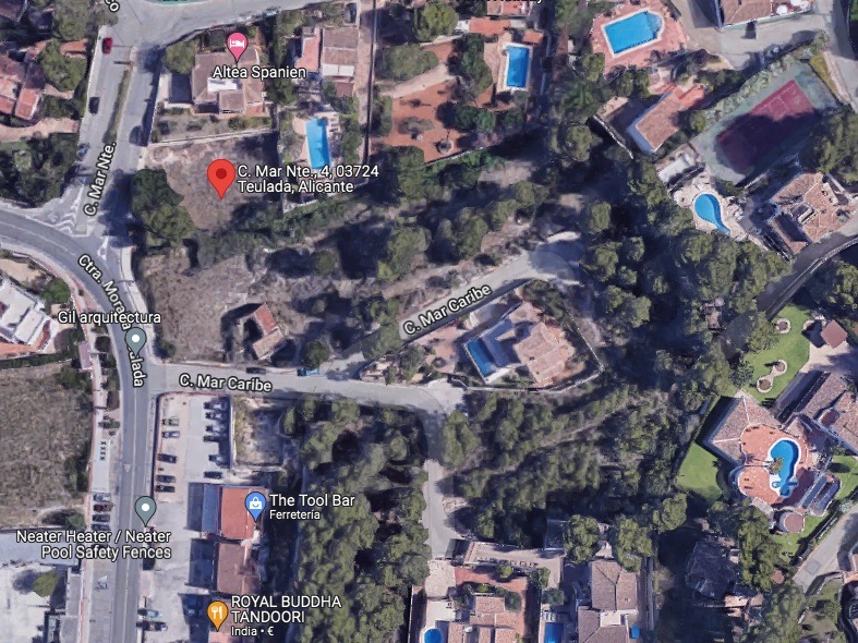 Satellite aerial view pinpointing the exact location of the plot in Moraira, showing its integration into a developed residential area near the coast.