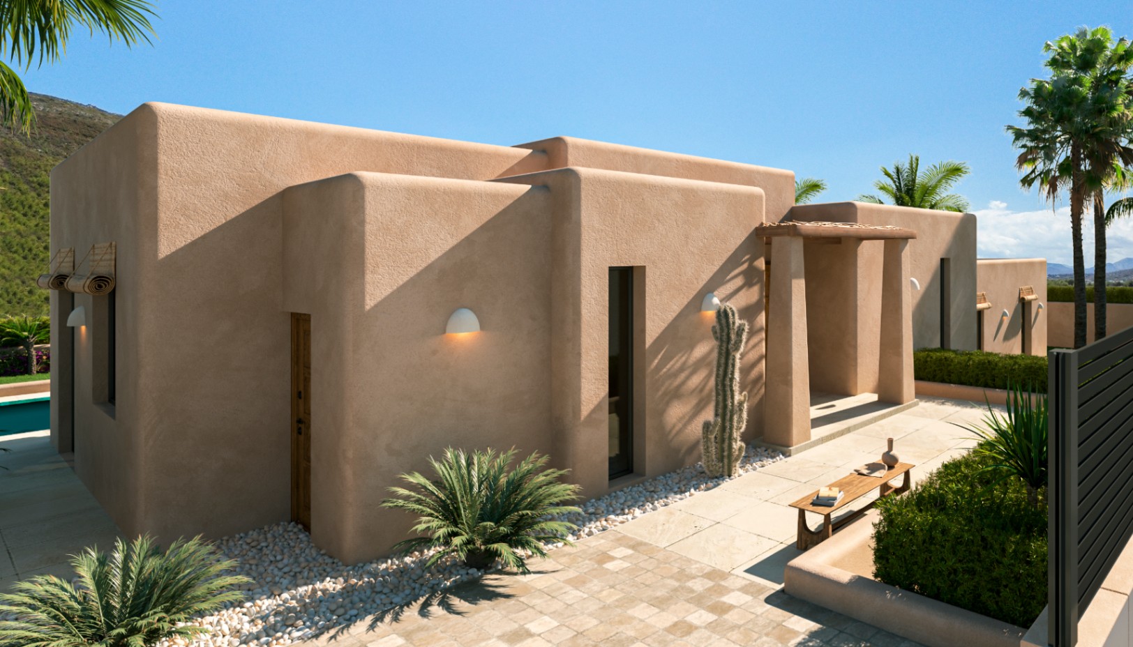 Modern Mediterranean exterior featuring earth-toned textured walls, rounded architectural lines, and a minimalist garden with cacti and stone pathways.