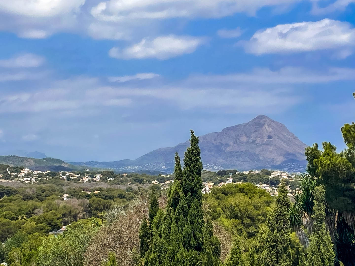 Panoramic views of the Montgó mountain and the surrounding valley, featuring lush Mediterranean greenery and a clear blue sky.