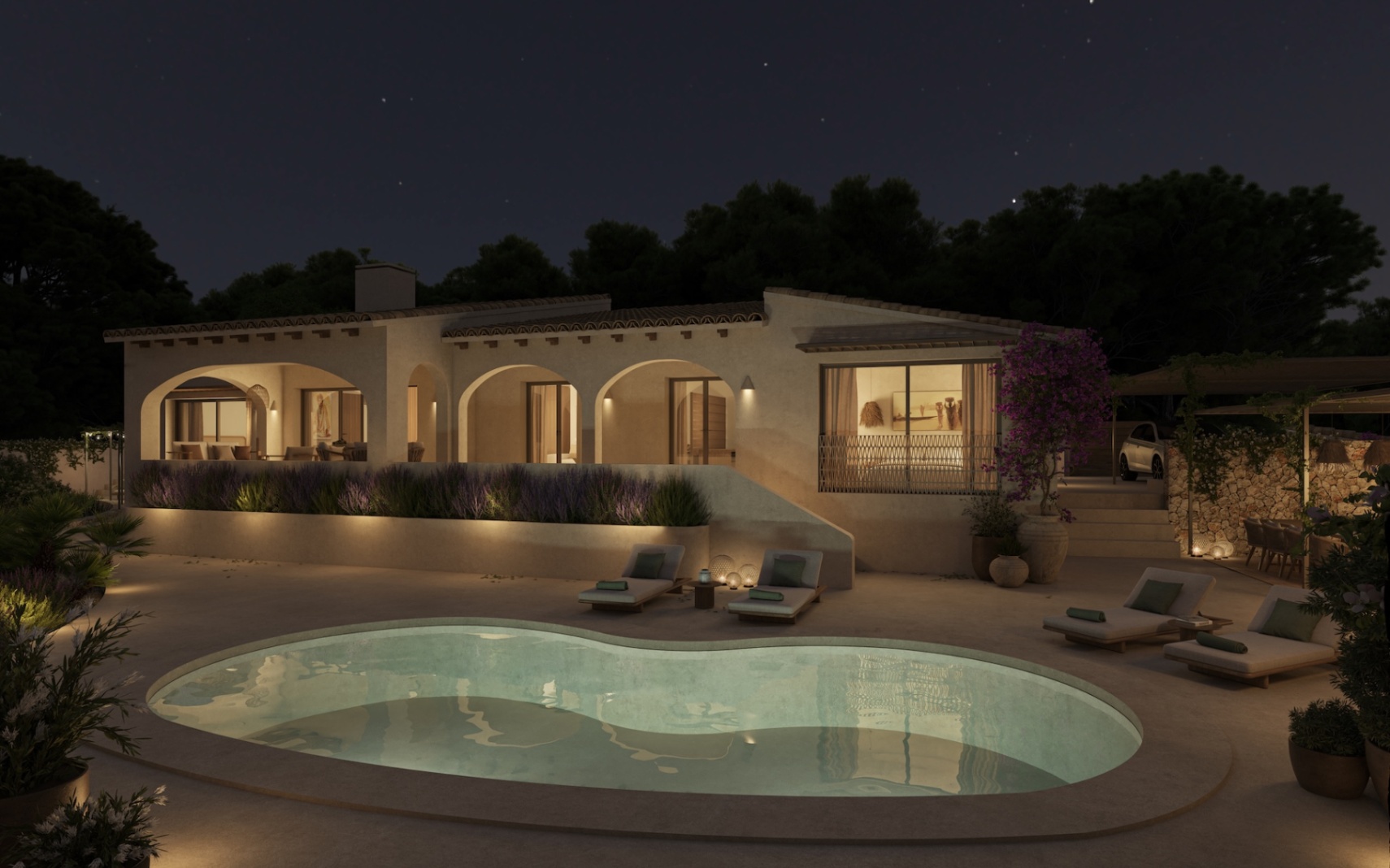 Night exterior view of the villa showcasing the organic-shaped pool, illuminated arched porches, and manicured Mediterranean gardens.
