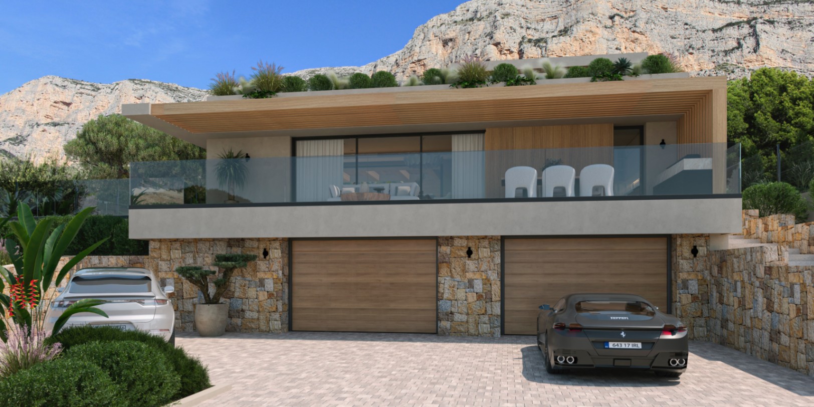 Exterior facade featuring natural stone walls, a double garage with wooden doors, and a glass-railed terrace set against the Montgó mountain backdrop.
