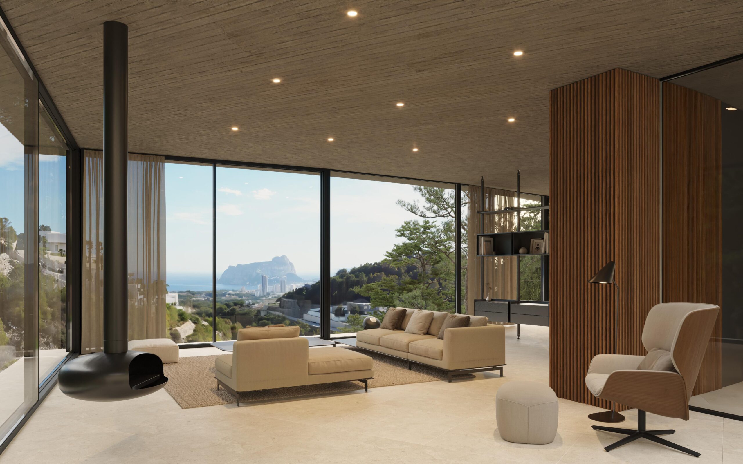 Modern living area featuring a suspended fireplace, concrete ceilings, and floor-to-ceiling windows with panoramic views of the Mediterranean coast and Peñón de Ifach.