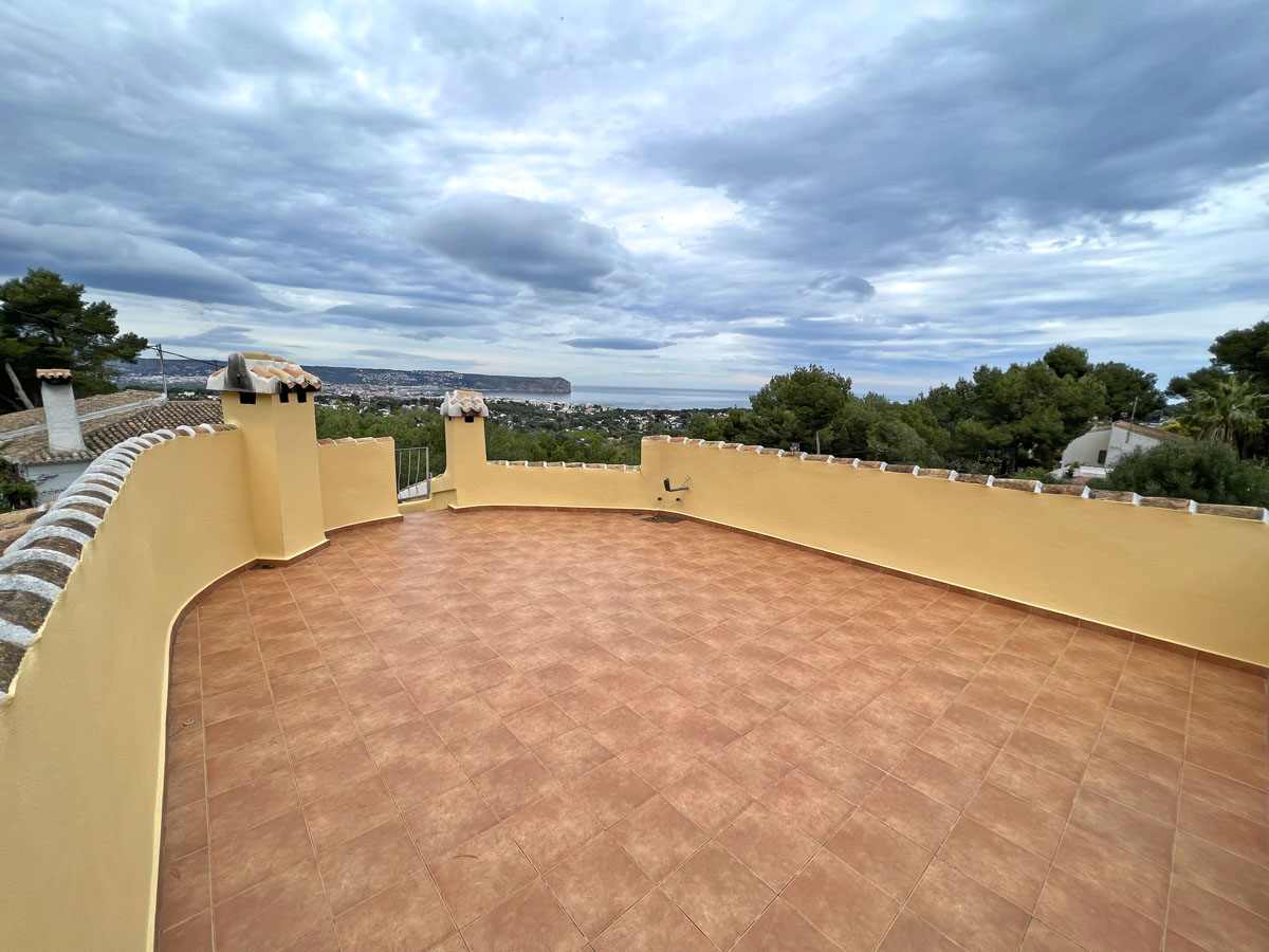 Spacious upper terrace featuring terracotta tiling and a curved perimeter wall with panoramic views of the Mediterranean Sea and Cabo San Antonio.