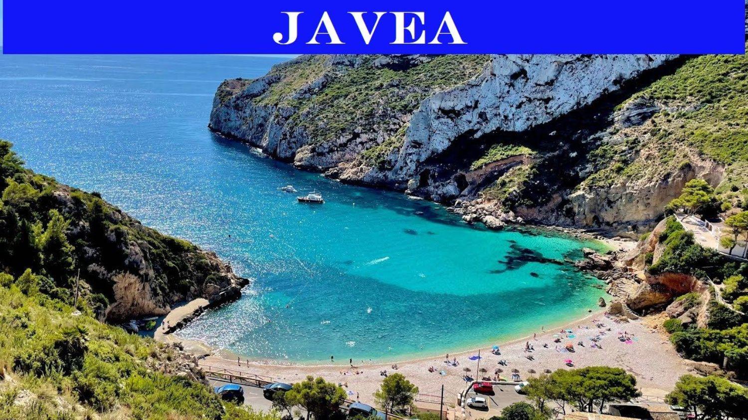 Aerial view of Cala de la Granadella in Jávea, showcasing crystal-clear turquoise waters surrounded by Mediterranean cliffs and lush coastal vegetation.