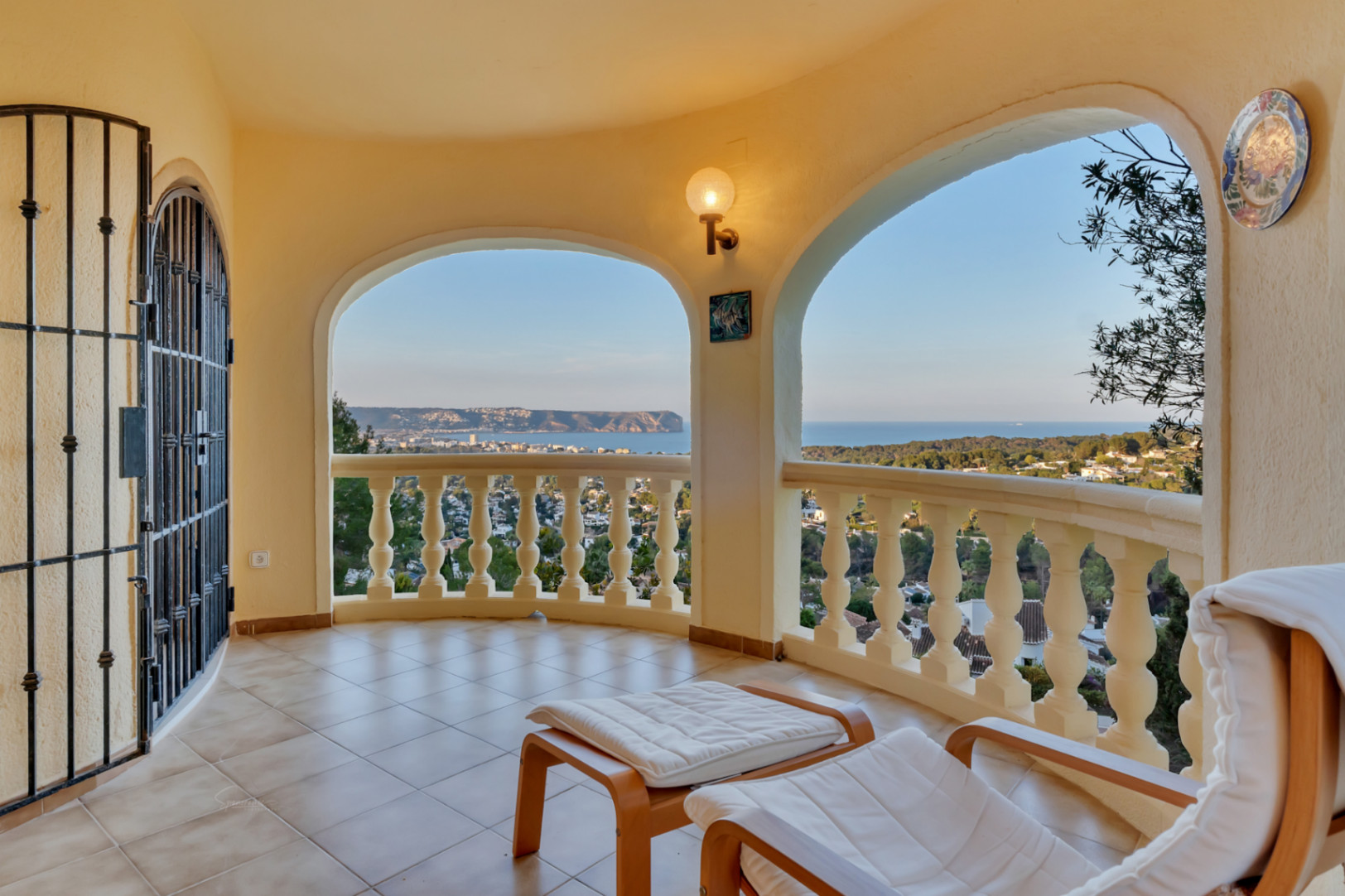 Covered terrace featuring traditional arches and stone balustrades, providing panoramic views of the Jávea bay and Cabo San Antonio coastline.