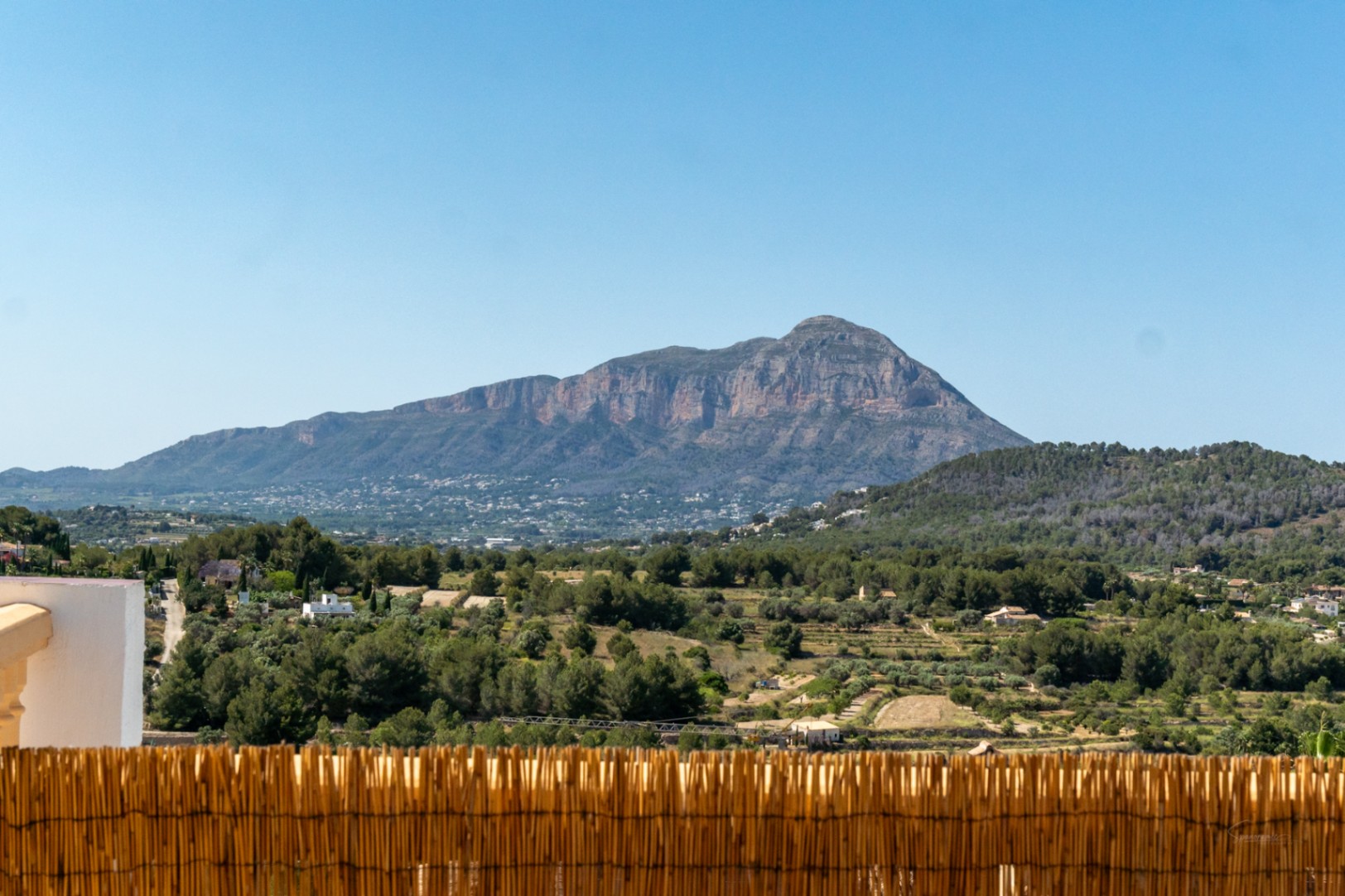 Clear panoramic views of the Montgó mountain range from the property, overlooking a valley of Mediterranean pine trees and rural landscape.