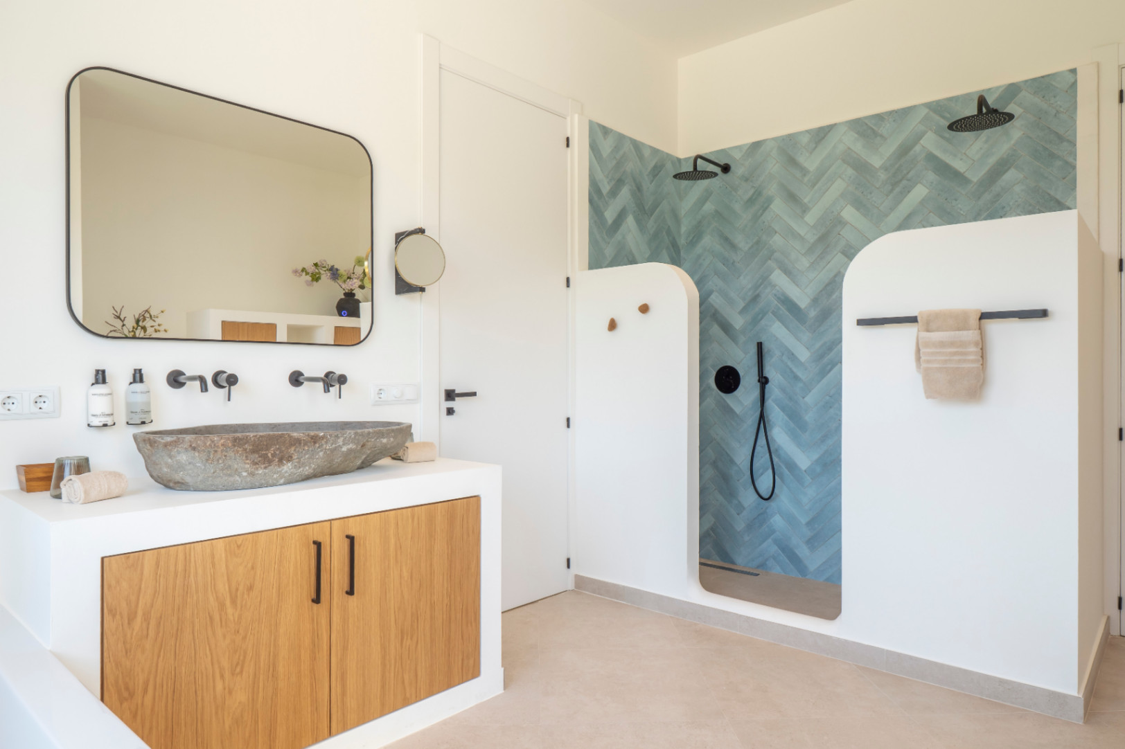 Bathroom detail with stone sink and shower featuring blue herringbone tiles in Jávea Villa.