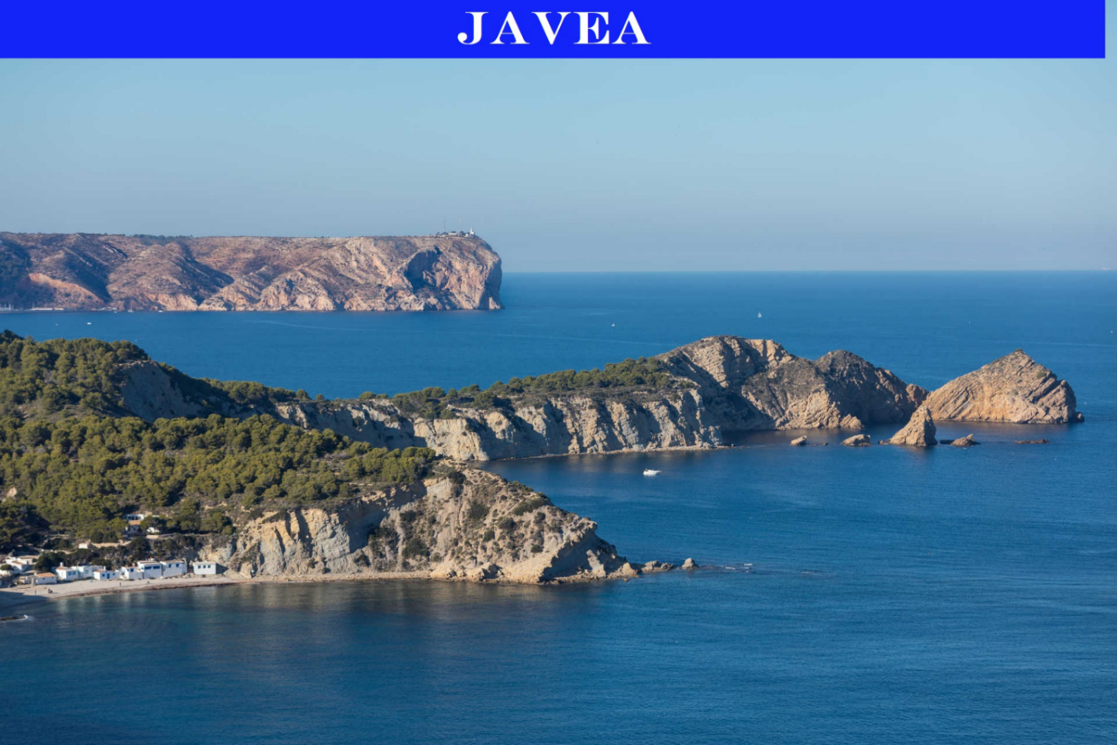 Panoramic view of the Jávea coastline, featuring rugged Mediterranean cliffs, pine-covered hills, and the turquoise waters near Portitxol bay.