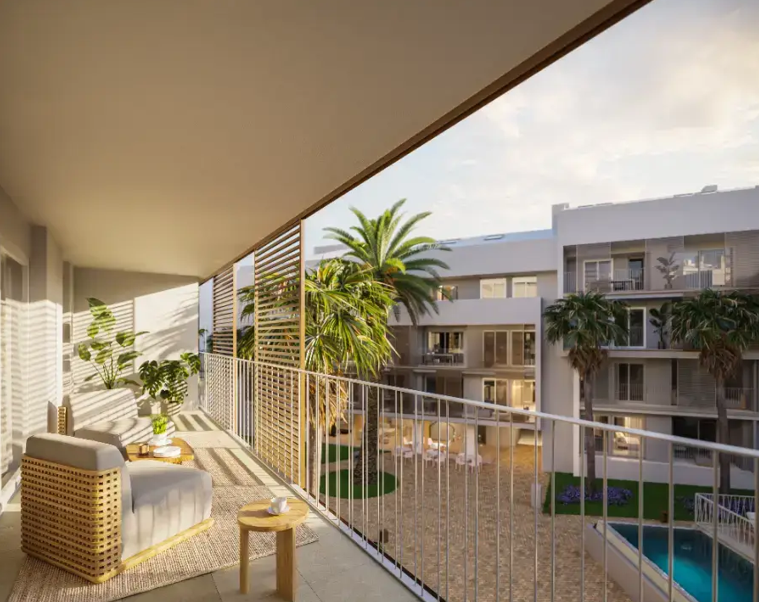 Covered terrace with white metal railings and wooden privacy screens, featuring lounge seating and views over the communal pool and landscaped courtyard.